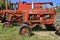 Old rusty tractor used for salvage and parts in a junkyard