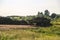 Old rusty trailer with manure fertilizer stands in  field to fertilize land before sowing