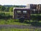 Old rusty trailer with manure fertilizer stands in  field to fertilize land before sowing