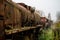 Old rusty trains. Old abandoned track, siding with dirty old trains.