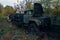 Old rusty truck at abandoned overgrown industrial area