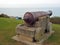 Old rusty war canon on coastline