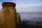 Old rusty wave breaker pillars in line