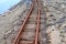 Old rusty weathered railroads right at the baltic sea coast