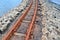 Old rusty weathered railroads right at the baltic sea coast