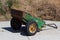 old rusty wheelbarrow garden is filled with dry grass