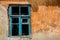 Old rusty window in devastated house