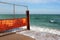 Old rusty wire fence on a seashore. Restricted area on a beach