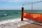 Old rusty wire fence on a seashore. Restricted area on a beach