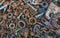 Old, rusty, worn metal details- bolts, nuts, bearings, chain lie