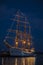 Old Sailing Ship Lit up in Midnight Blue Sky