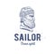 Old sailor logo or label. Seaman with a beard. Hand drawn illustration. Hipster logotype. Profile view. Vintage design.