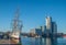 Old sailship in a harbor and modern buildings