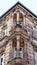 Old sandstone building with decorative corner balconies