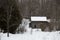 Old sawn log cabin in the snow in winter landscape