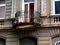 Old semi round balcony with wrought iron balustrade and stucco exterior