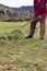 old senior farmer raking lawn