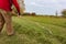 old senior farmer raking lawn