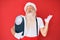 Old senior man on diet wearing traditional santa claus costume celebrating victory with happy smile and winner expression with