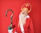 Old senior man with grey hair and long beard wearing traditional saint nicholas costume looking sleepy and tired, exhausted for