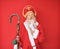 Old senior man with grey hair and long beard wearing traditional saint nicholas costume thinking concentrated about doubt with