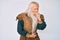 Old senior man with grey hair and long beard wearing viking traditional costume feeling unwell and coughing as symptom for cold or