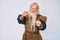 Old senior man with grey hair and long beard wearing viking traditional costume pointing fingers to camera with happy and funny