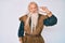 Old senior man with grey hair and long beard wearing viking traditional costume smiling and confident gesturing with hand doing