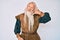 Old senior man with grey hair and long beard wearing viking traditional costume smiling doing phone gesture with hand and fingers