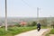 Old senior man riding a motorcycle moped, biking on the rural countryside roads of Ripanj, in the agricultural part of serbia