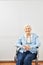 Old senior woman is sitting smiling in wheelchair