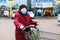 Old senior woman wear medical mask, protection against pandemic coronavirus disease. 90 years retired female lady push