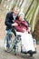 Old senior woman in wheelchair with careful son