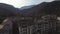 Old settlement at the top of mountain hill. Shot. Aerial view of the old abandoned residential buildings surrounded by