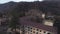 Old settlement at the top of mountain hill. Shot. Aerial view of the old abandoned residential buildings surrounded by