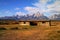 An old settlers cabin foreground the Tetons