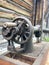 Old sewing machine, with manual drive. Covered with corrosion, dust and cobwebs. Against the background of a wooden abandoned barn