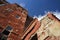 Old shabby abandoned building of red bricks against clear blue s
