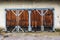 Old shabby locked wooden garage doors. Blue metal frame.