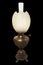 The old, shabby sweatched kerosene lamp. The lamp of past times. Isolated On a black background. Made by Germany