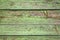 Old shabby wooden background with flaking green paint