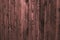 Old shabby wooden pink fence, wood surface. Dilapidated pink wooden boards, grunge wood pattern texture background, wooden planks.