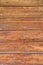 Old shabby wooden wall painted faded brown