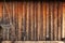 Old shabby worn wooden boards - background, wall of vintage house. Rural texture