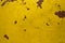 A old shabby yellow wall with scratches and red spots. rough surface texture