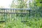 Old shaky wooden picket fence closeup view