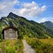 Old shelter with path in alpien mountains landscape