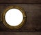 Old ship or boat porthole on wooden wall