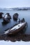 Old ships graveyard at the Barents sea rocky shore.