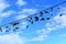 Old Shoes hanging on electrical wire against a blue sky